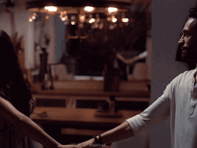 Man And Woman Holding Hands In Dark Room GIF