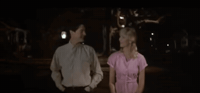 Man And Woman Holding Hands In Dark Room GIF