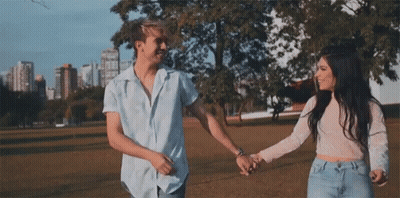 Man And Woman Holding Hands In Park GIF