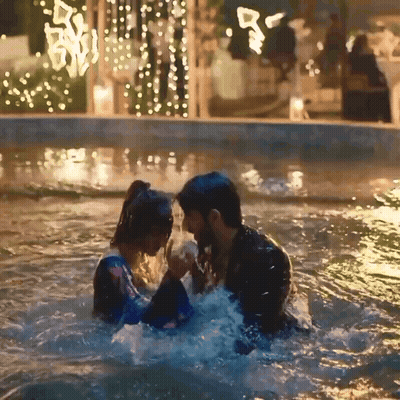 Man And Woman Holding Hands In Pool GIF