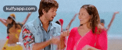 Man And Woman Holding Hands On Beach GIF