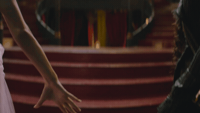 Man And Woman Holding Hands On Red Carpet GIF