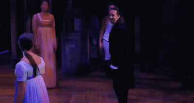 Man And Woman Holding Hands On Stage GIF