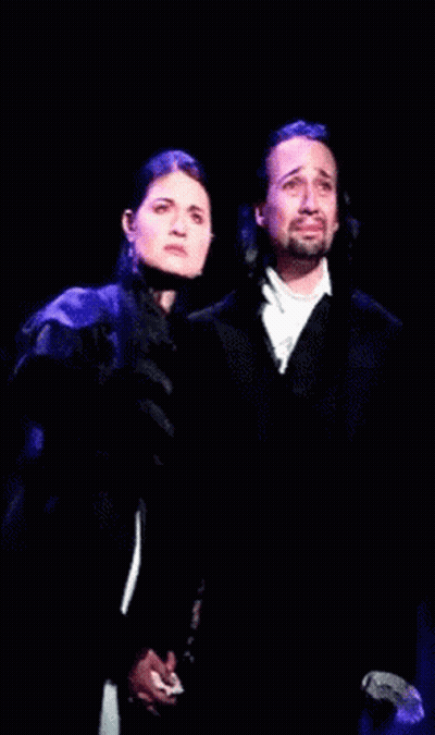 Man And Woman Holding Hands On Stage GIF