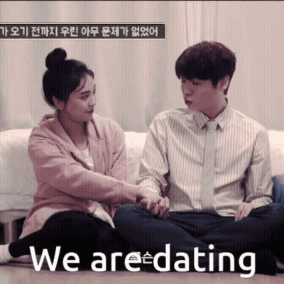 Man And Woman Holding Hands Saying We Are Dating GIF