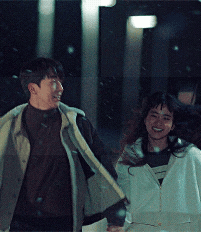 Man And Woman Holding Hands Smiling In Snow GIF