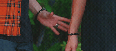 Man And Woman Holding Hands With Bracelets GIF