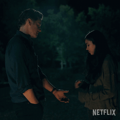 Man And Woman Holding Hands With Netflix Logo GIF