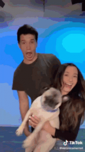 Man And Woman Holding Pug GIF