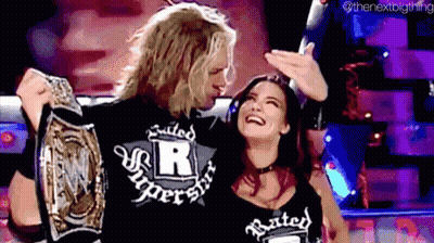 Man and Woman Holding Wrestling Championship Belt
