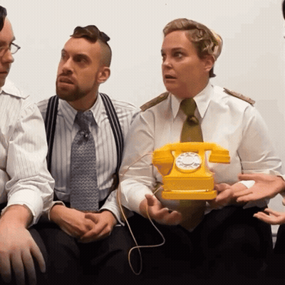 Man And Woman Holding Yellow Telephone GIF