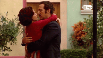 Man And Woman Hugging And Kissing In Front Of Building GIF