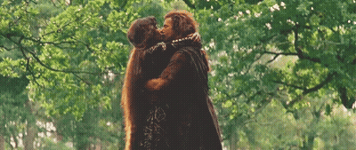 Man And Woman Hugging And Kissing In Woods GIF