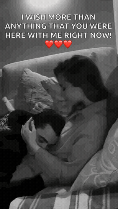 Man And Woman Hugging And Kissing On Couch GIF