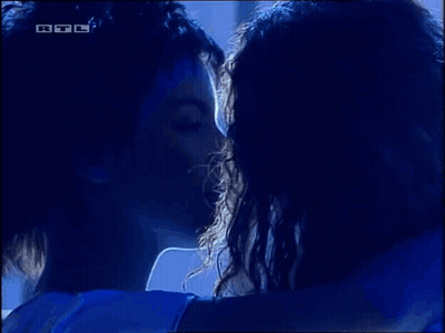 Man And Woman Hugging In Dark Room With RTL Logo GIF