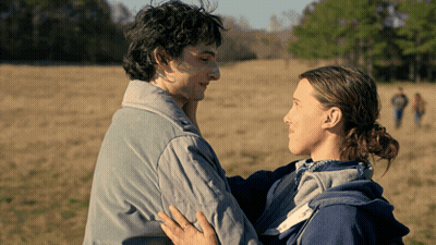 Man And Woman Hugging In Field With Trees GIF