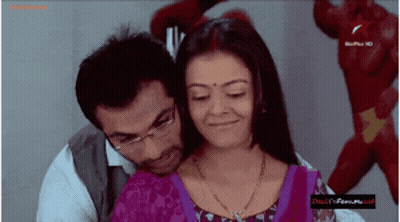 Man and Woman Hugging in Front of Bollywood Sign