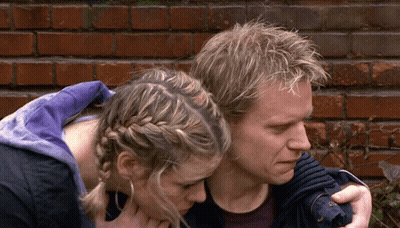 Man And Woman Hugging In Front Of Brick Wall GIF