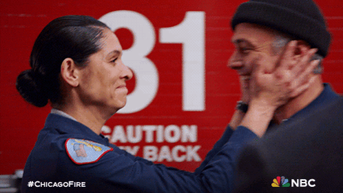 Man And Woman Hugging In Front Of Caution Stay Back Sign GIF