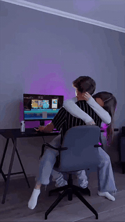 Man And Woman Hugging In Front Of Computer Monitor GIF