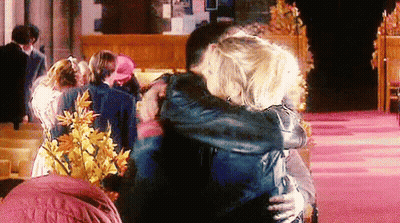 Man And Woman Hugging In Front Of Crowd GIF