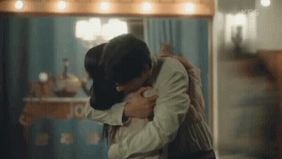 Man And Woman Hugging In Front Of Mirror GIF