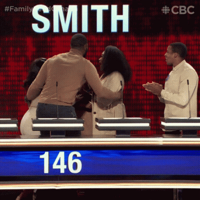 Man And Woman Hugging In Front Of Smith Sign GIF