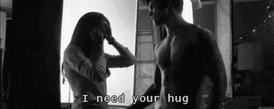 Man And Woman Hugging In Front Of Window GIF
