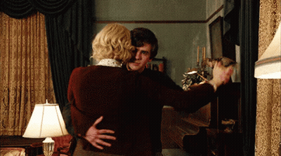 Man And Woman Hugging In Living Room With Lamp GIF