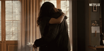Man And Woman Hugging In Room With Netflix Logo GIF