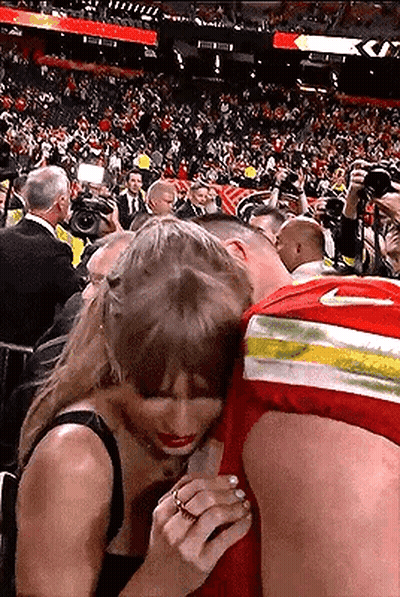 Man And Woman Hugging In Stadium GIF