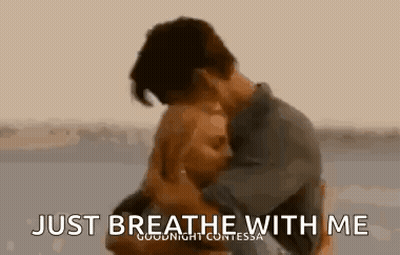 Man And Woman Hugging On Beach Saying Just Breathe With Me GIF