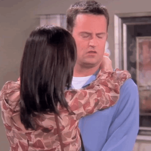Man And Woman Hugging Woman Touching Man's Neck GIF