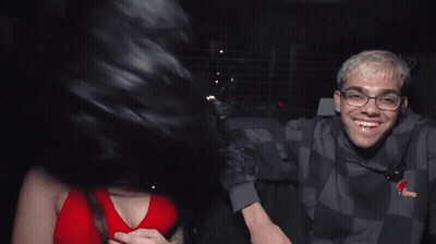 Man And Woman In Back Seat Of Car Wearing Tommy Jeans Sweatshirt GIF