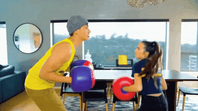 Man And Woman In Boxing Gloves Living Room GIF