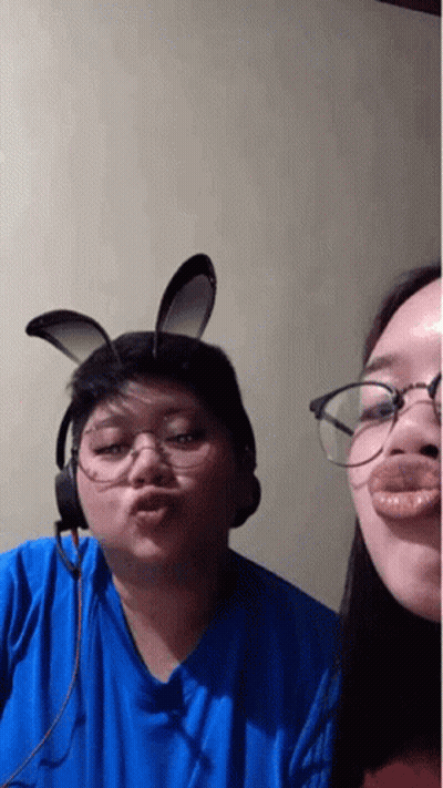 Man And Woman In Bunny Ears And Glasses Making A Face GIF