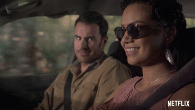 Man And Woman In Car With Netflix Logo GIF