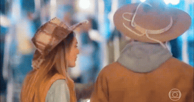 Man And Woman In Cowboy Hats Holding Hands GIF