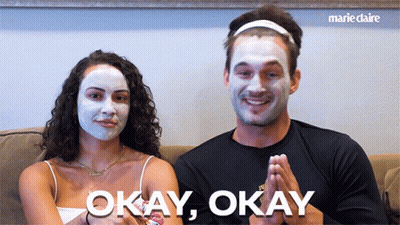 Man And Woman In Face Masks Saying Okay Okay GIF