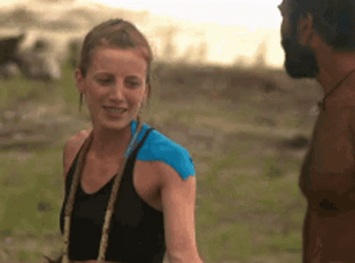 Man And Woman In Field With Blue Shoulder Tape GIF
