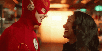 Man And Woman In Flash Costumes GIF