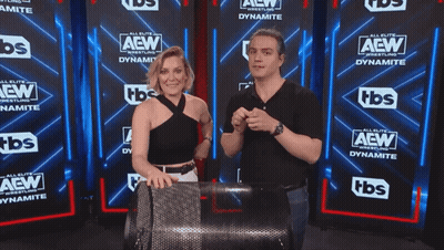 Man And Woman In Front Of AEW Wall GIF