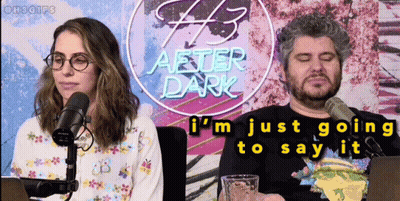 Man And Woman In Front Of After Dark Neon Sign GIF