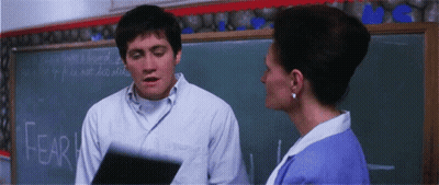 Man And Woman In Front Of Blackboard Saying Fear GIF
