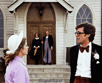 Man And Woman In Front Of Church With Dammit Janet On Steps GIF