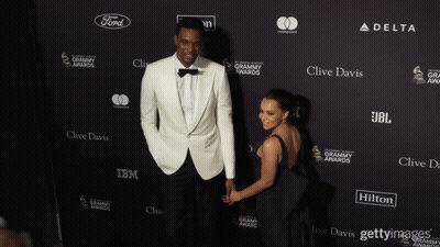 Man And Woman In Front Of Clive Davis IBM JBL Wall GIF