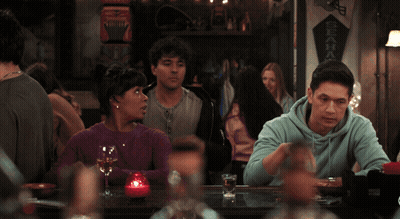 Man And Woman In Front Of Colorful Light GIF