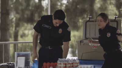 Man And Woman In Front Of Cooler Saying Seattle Fire GIF