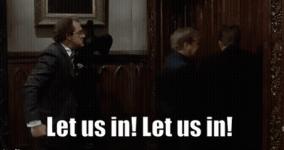 Man And Woman In Front Of Door Saying Let Us Out GIF