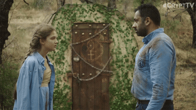 Man And Woman In Front Of Door With Female Symbol GIF